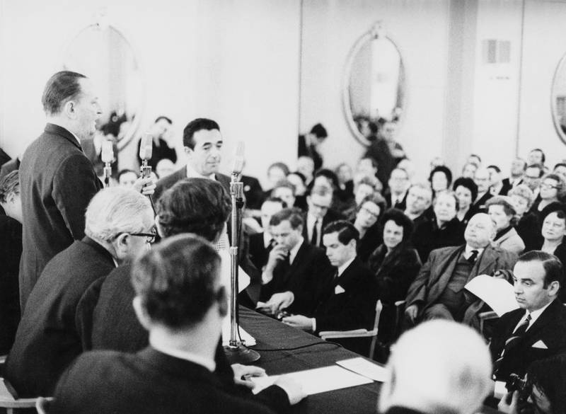 LONDON, UNITED KINGDOM - JANUARY 02:  (FILE PHOTO) News Of The World chairman William Carr (standing, left) addresses shareholders at a meeting as rival publishers Robert Maxwell (standing, centre, left) and Rupert Murdoch (bottom, right) await a vote on their respective bids for the paper at the Connaught Rooms on January 2, 1969 in London, England. The phone hacking scandal surrounding News International has escalated with the resignation of the Metropolitan Police Commissioner Sir Paul Stephenson and the arrest of former News of the World Editor Rebekah Brooks.  (Photo by Ted West/Central Press/Hulton Archive/Getty Images) *** Local Caption ***  119446068.jpg