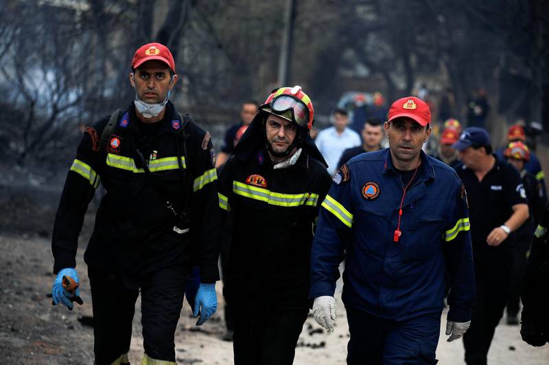 Rescuers arrive at the area where bodies were found following a wildfire at the village of Mati, near Athens. Reuters
