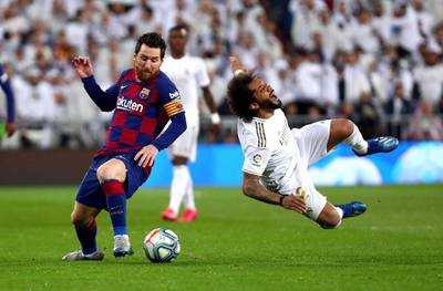 Barcelona's Lionel Messi reacts after fouling Real Madrid defender Marcelo. Reuters