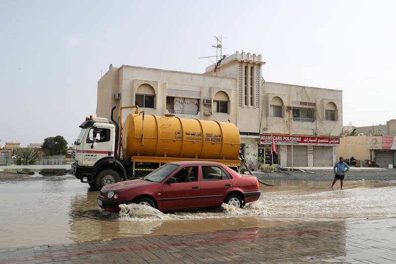 A tanker clears a waterlogged road after flooding in the Kalba area of Sharjah. Pawan Singh / The National 