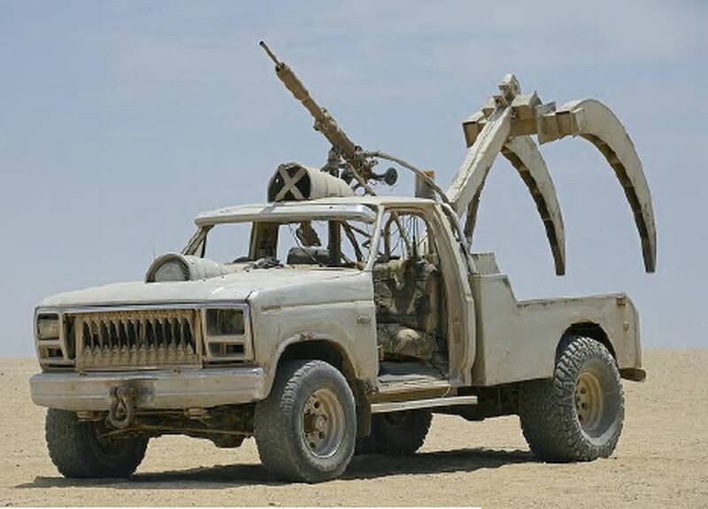 Sabre Tooth F250 Claw Car: a repurposed F250 tow truck, sporting a massive harpoon for lassoing quarry, and a vicious pair of steel ‘teeth’ to bite into the earth and slow a victim’s vehicle