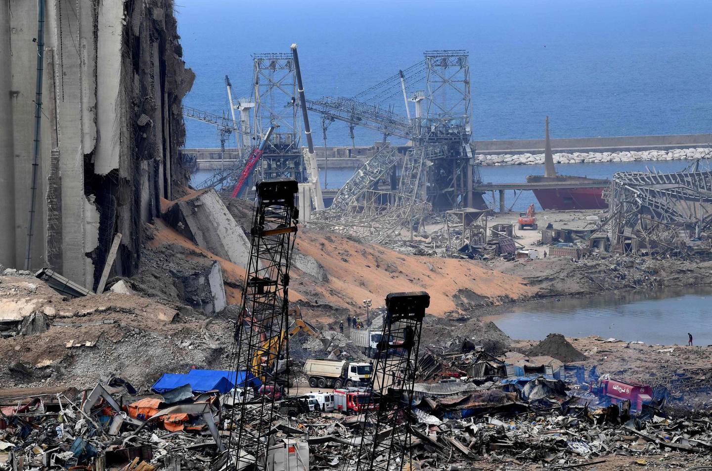 A picture taken on August 7, 2020, shows a view of destroyed grain silos amid the devastation in the port of Beirut, the site of a massive blast which shook the Lebanese capital. Three days after the monster explosion that disfigured the city in a matter of seconds, the clock was already ticking down on any potential survivors' chances, as rescuers from Lebanon, France, Germany, Russia and other countries worked shifts to try to find an entrance to a control room buried under metres (yards) of rubble.
 / AFP / -
