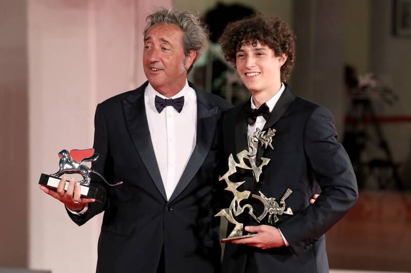 Director Paolo Sorrentino and Filippo Scotti pose with the Silver Lion Grand Jury Prize and the Marcello Mastroianni Award for Best New Young Actor for 'The Hand of God. Getty Images