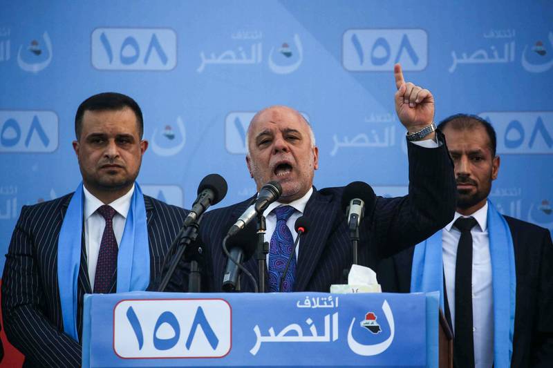 Iraqi Prime Minister Haider al-Abadi (C) speaks as he presents candidates running on his list during an electoral campaign rally in the holy Iraqi city of Karbala on May 4, 2018.  / AFP PHOTO / Mohammed SAWAF