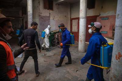 Volunteers disinfect an overcrowded housing complex to prevent the spread of coronavirus in Sale, near Rabat, Morocco. AP Photo