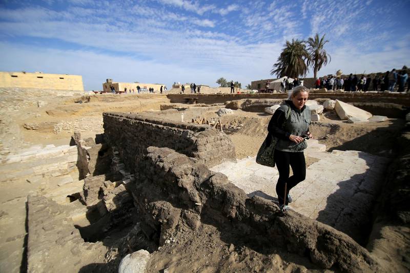 A woman walks at the site of a recent discovery at the Saqqara necropolis south of Cairo, Egypt. Reuters