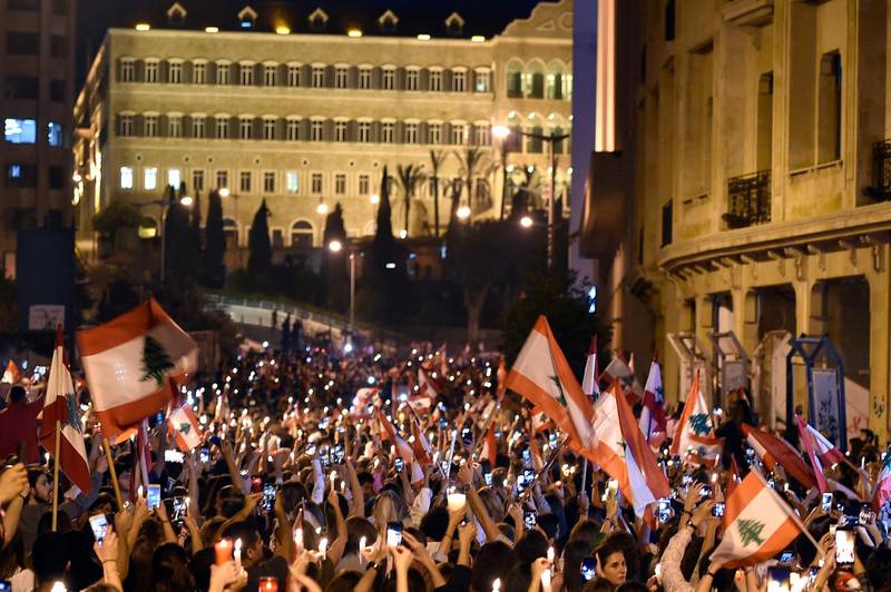 Lebanese women carry national flags and lighted candles in support of the anti-government protests, in front of the Lebanese Government palace in downtown Beirut, Lebanon. EPA