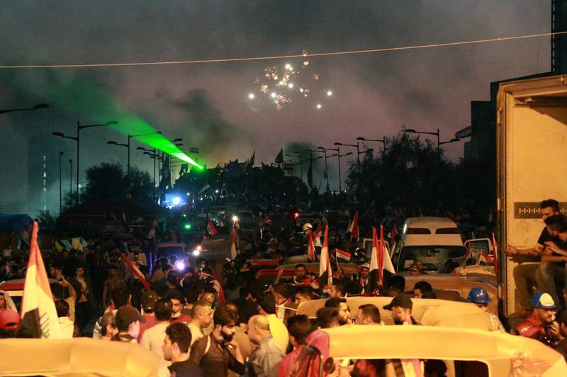 Smoke clouds rise from the site of clashes between Iraqi protesters and security forces near Tahrir square in central Baghdad, Iraq.  EPA