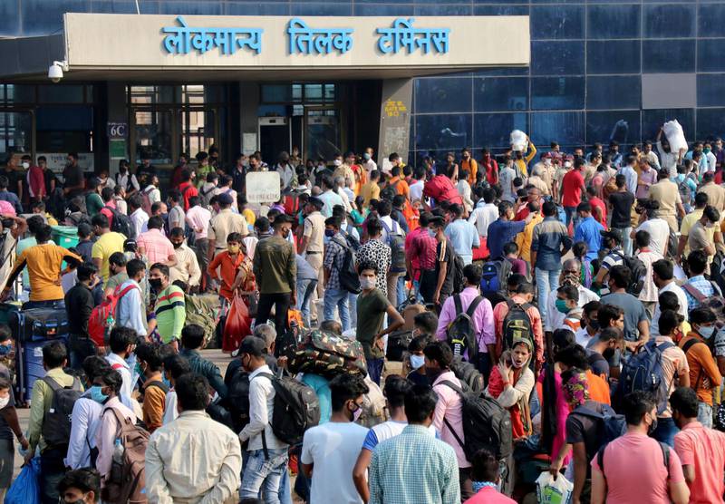 People wearing protective masks wait to enter the Lokmanya Tilak Terminus railway station in Mumbai, India. Reuters