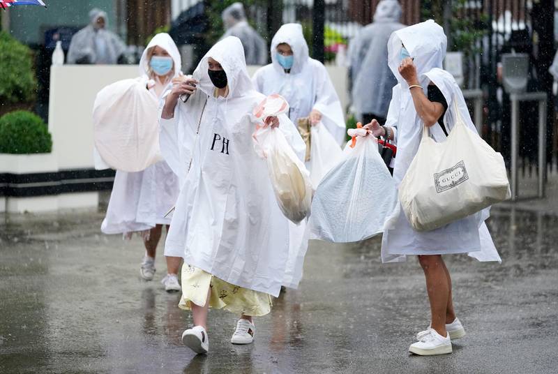 Racegoers wear ponchos to shield themselves from the rain as they arrive on day four of Royal Ascot at Ascot Racecourse. Andrew Matthews/PA Wire