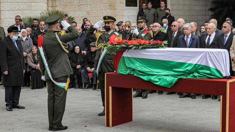 Palestinian President Mahmud Abbas (L) pays his respects during the funeral of Mr Qurei in Ramallah on February 22. AFP