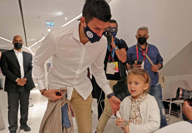 Novak Djokovic speaks with his daughter, Tara, during a visit to the Serbian pavilion at Expo 2020 Dubai. AFP