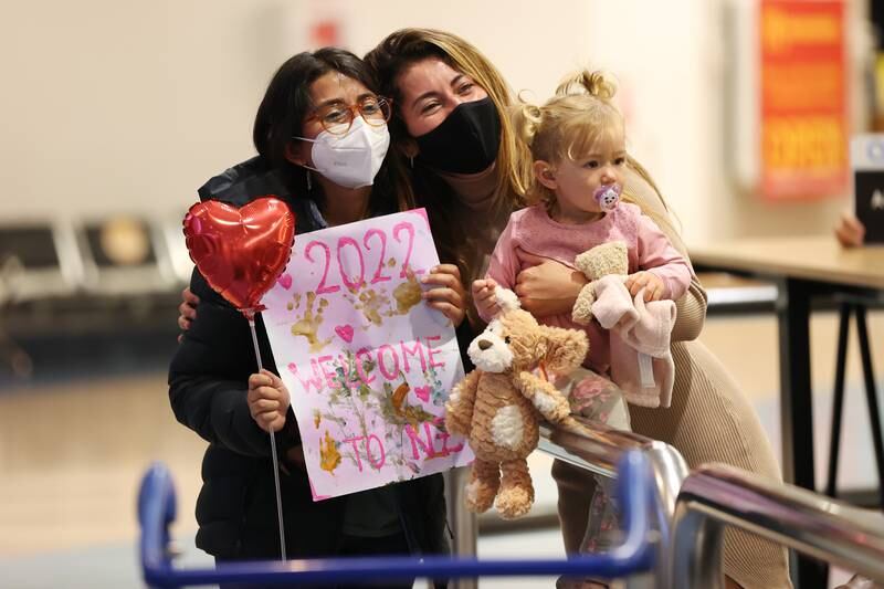 Millions of travellers have shrugged off the threat still posed by the pandemic to see friends and family for the first time in years, such as this family in Auckland, New Zealand. Fiona Goodall / Getty Images