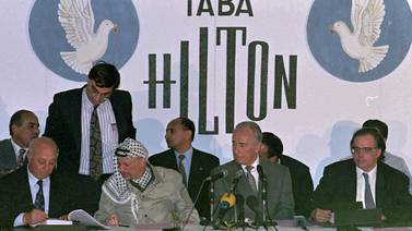 PLO chairman Yasser Arafat and Israeli foreign minister Shimon Peres at the Hilton hotel in Taba, Egypt, September 1995. AP Photo