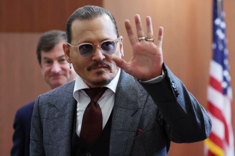 Depp reacts to fans in the courtroom. AP