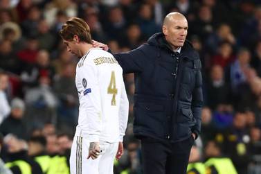 Real Madrid's Sergio Ramos looks dejected as he walks past coach Zinedine Zidane after being sent off against Manchester City. Reuters