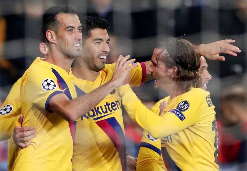 Luis Suarez, centre,  celebrates with teammates after scoring their second goal. EPA