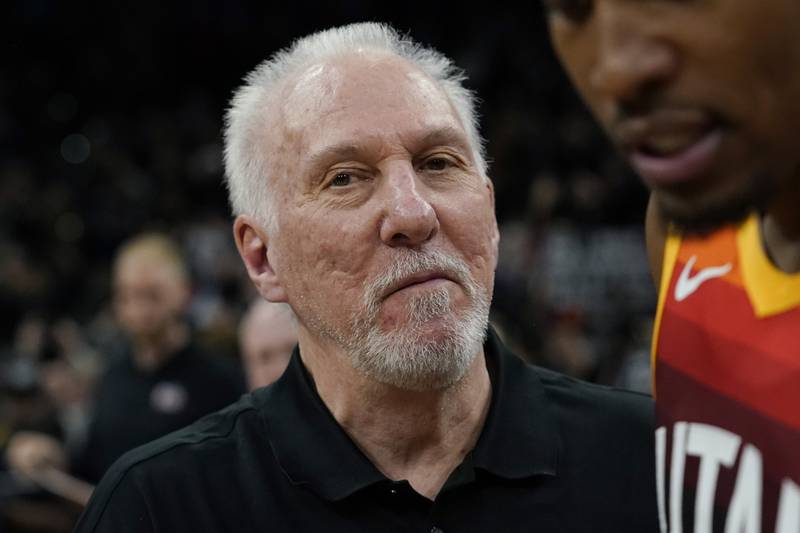 San Antonio Spurs head coach Gregg Popovich walks across the court after an NBA basketball game against the Utah Jazz.  The Spurs won, making Popovich the all-time winningest coach in NBA regular-season history.  AP Photo