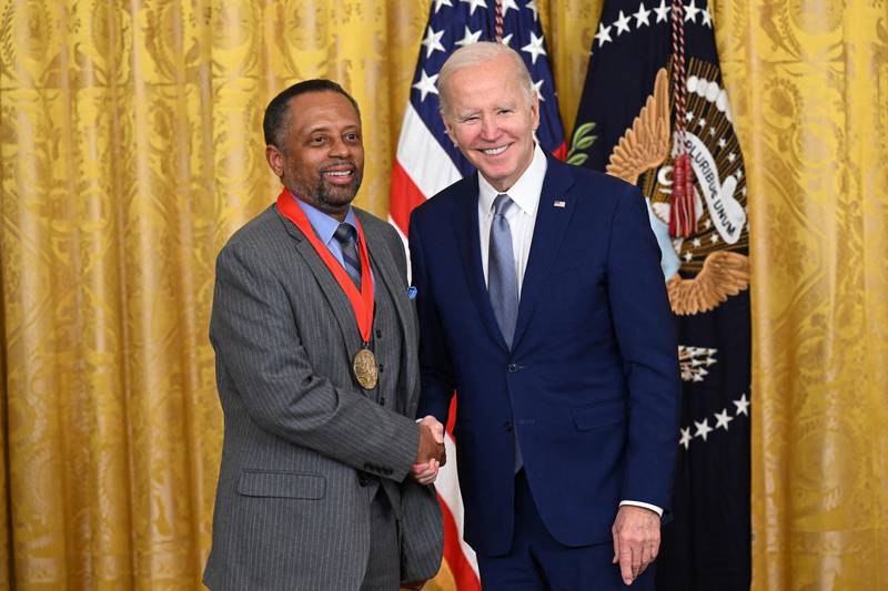 Mr Biden awards historian Earl Lewis with the 2021 National Humanities Medal. AFP