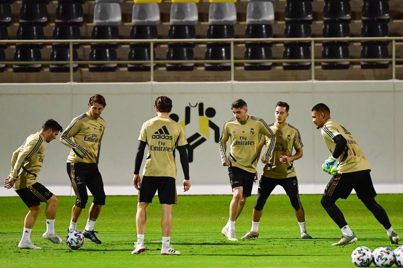 Real Madrid's Spanish midfielder Brahim Diaz (L) passes the ball during a training session at the King Abdullah Sport City Stadium. AFP