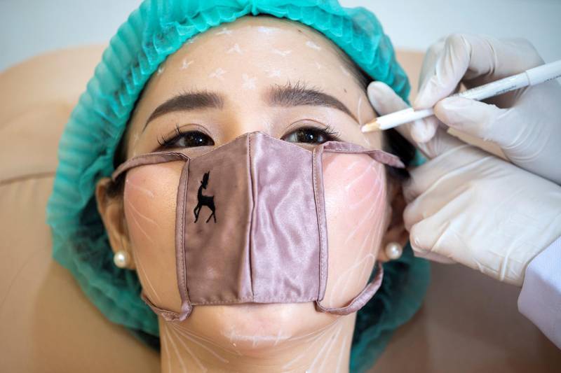 A customer wears a mini face mask during a treatment at the Waleerat beauty clinic after the Thai government eased isolation measures, amid the coronavirus disease (COVID-19) outbreak in Bangkok, Thailand. REUTERS