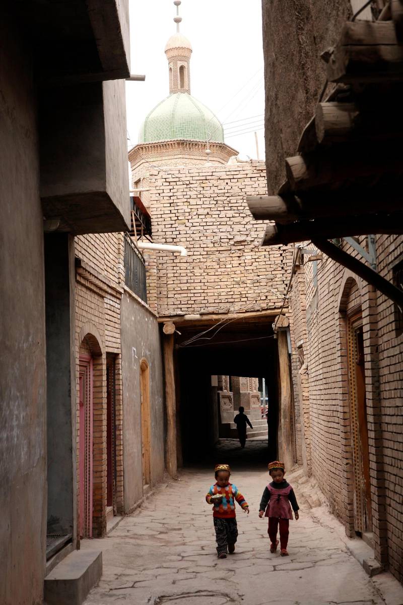 Two Uighur children walking through the Old Town of Kashgar. Paul Mooney for The National