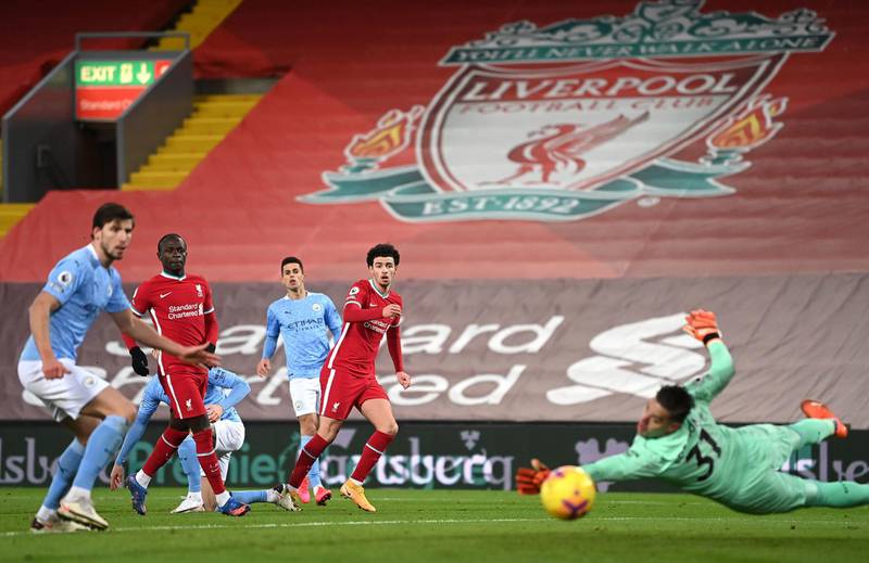 Liverpool's Curtis Jones shoots wide of the City goal. PA