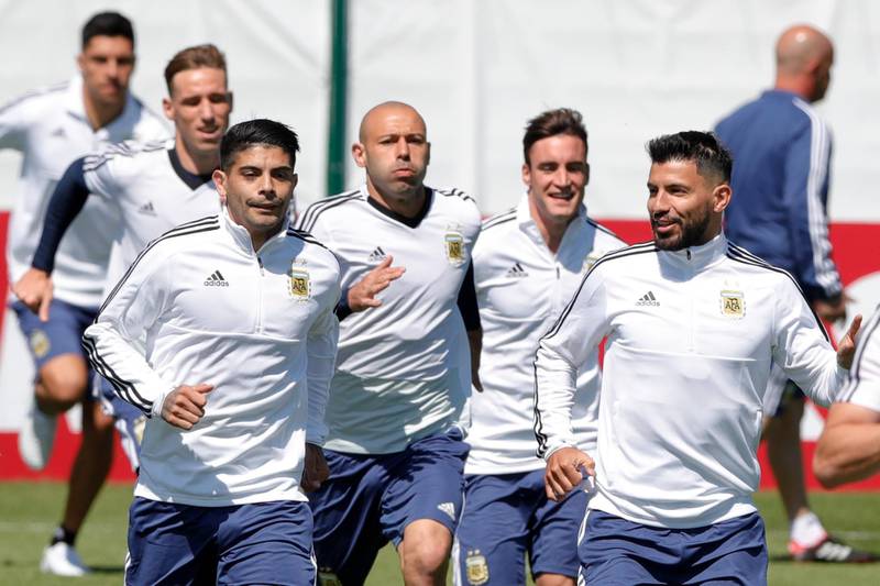 From right to left, Sergio Aguero, Nicolas Tagliafico, Javier Mascherano and Ever Banega jog during training. Ricardo Mazalan / AP Photo