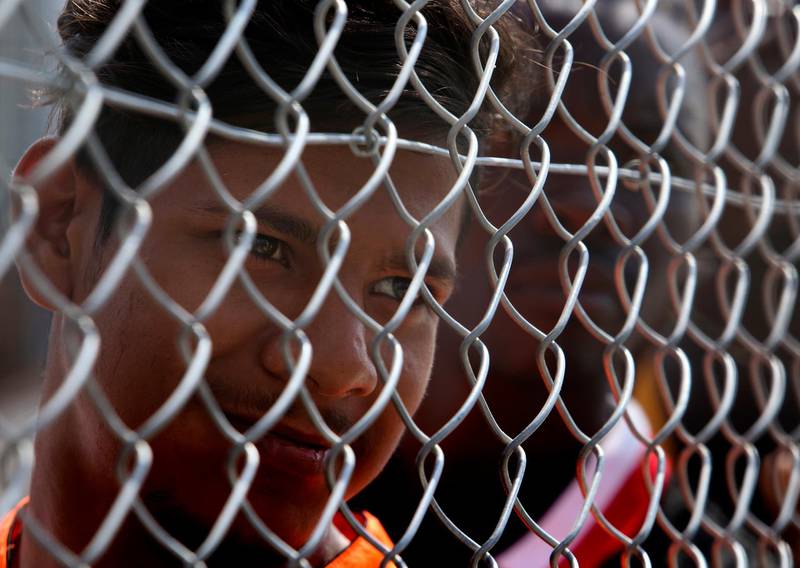 A migrant stands behind a fence inside a refugee camp in Kokkinotrimithia outside of capital Nicosia, Cyprus. AP Photo