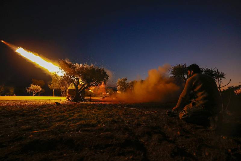 A Syrian rebel fires a rocket towards regime forces positions in the southern countryside of Syria's Aleppo province.   AFP