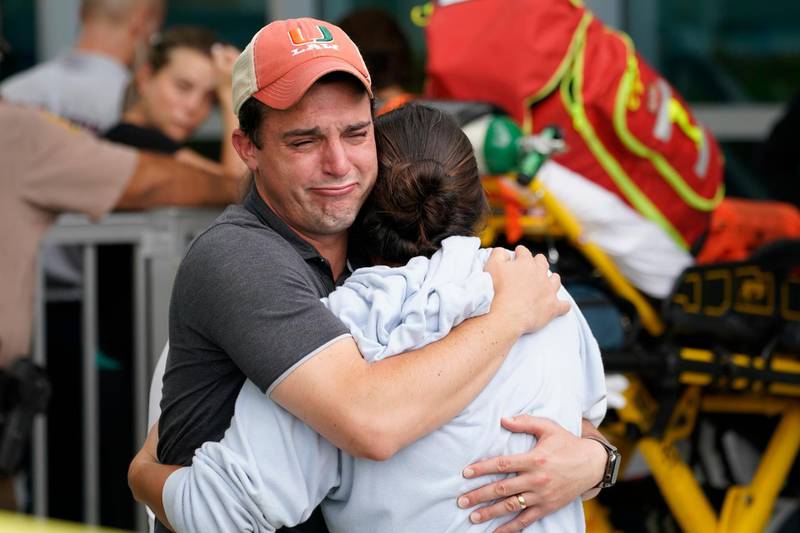 A couple embrace as they wait for news of survivors from a condominium that collapsed in Surfside, Florida. Marta Lavandier / AP Photo