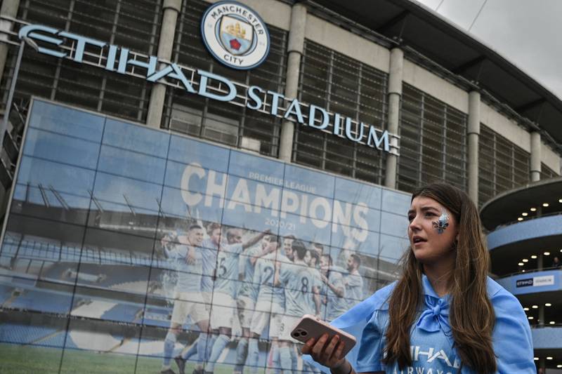 A Manchester City fan outside the Etihad Stadium. AFP