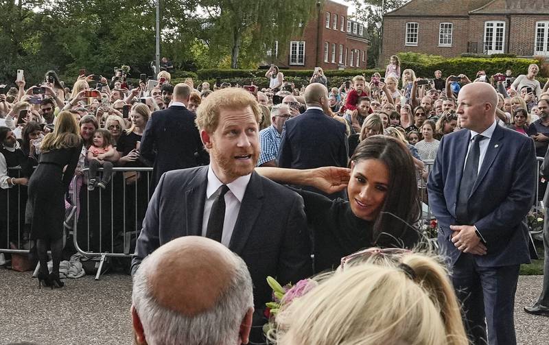 The royals meet people outside Windsor Castle. AP
