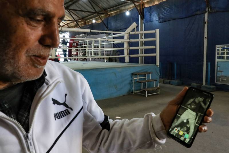 Mr Zlitni, now 63, shows a photo of himself as a boxer in his prime. He has reunited with former fighters and worked to revive boxing, re-establishing the national federation