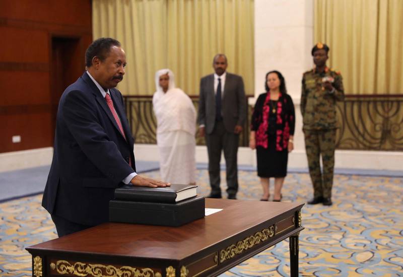 epa07784904 Sudan's new Prime Minister Abdalla Hamdok (L) swears in during a ceremony at the presidential palace in Khartoum, Sudan, 21 August 2019. The Sudanese opposition and military council signed on 17 August a power sharing agreement. The agreement sets up a sovereign council made of five generals and six civilians, to rule the country until general elections. Protests had erupted in Sudan in December 2018, culminating in a long sit-in outside the army headquarters which ended with more than one hundred people being killed and others injured. Sudanese President Omar Hassan al-Bashir stepped down on 11 April 2019.  EPA/MARWAN ALI
