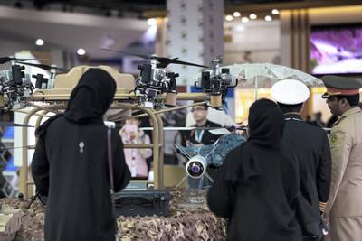 Abu Dhabi, U.A.E., February 20, 2019. INTERNATIONAL DEFENCE EXHIBITION AND CONFERENCE  2019 (IDEX) Day 4--  Colour images.--  Visitors check out some drones at the show.Victor Besa/The NationalSection:  NA