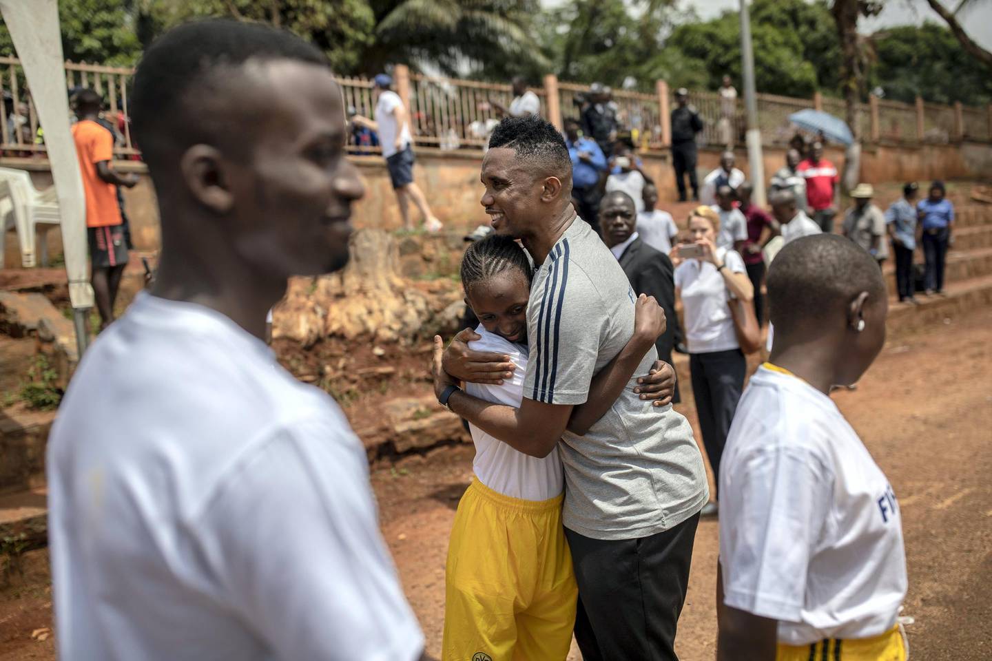 YAOUNDE, CAMEROON - MARCH 18: FIFA Legend Samuel Eto‚Äôo hugs a child during his visit in school, event organized by FIFA Foundation-supported NGO, Sport and Cooperation Network, on March 18, 2019 in Yaounde, Cameroon. (Photo by Maja Hitij - FIFA/FIFA via Getty Images)