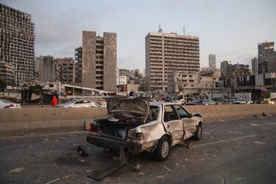 A vehicle stands damaged on a road following a large explosion at the port area of Beirut. Bloomberg