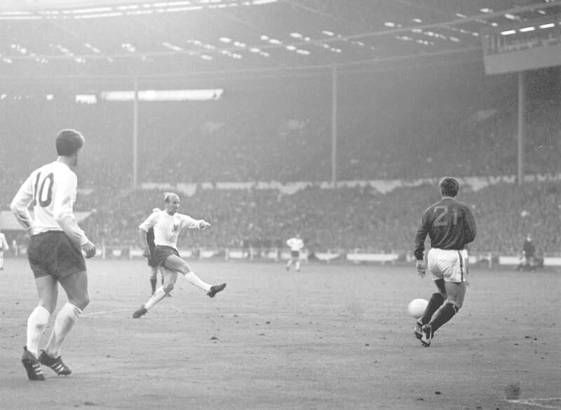 Bobby Charlton scores England's second goal as Portugal's Jose Carlos runs in to try and intercept during the World Cup semi-final match at Wembley, 27th July 1966. England won the match 2-1. (Photo by Central Press/Hulton Archive/Getty Images)