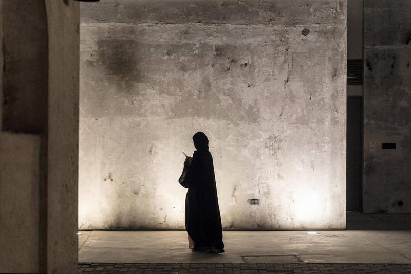 SHARJAH, UNITED ARAB EMIRATES. 30 September 2017. STANDALONE. Woman walk along the heritage area in Sharjah at night during an art tour of the Sharjah Art Foundation's Artists in residence installation unveiling. (Photo: Antonie Robertson/The National) Journalist: None. Section: Standalone.