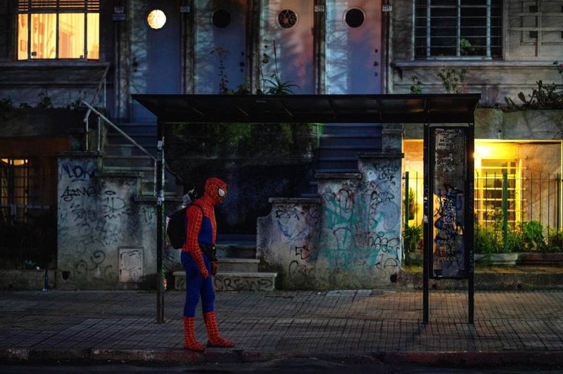 A man wearing a Spiderman costume waits for the bus amid the new coronavirus pandemic in Montevideo, Uruguay. AP Photo
