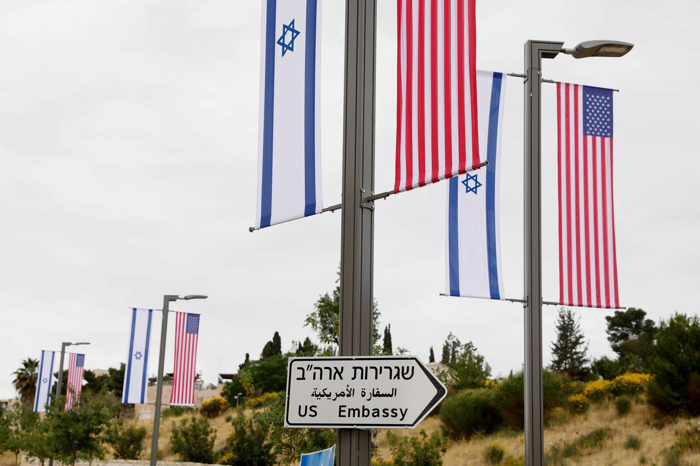 epaselect epa06718506 A new road sign and flags are placed at the road leading to the US consulate in the Jewish neighborhood of Arnona on the East-West Jerusalem line in Jerusalem, Israel, 08 May 2018. Media reports that Trump's administration will officially transfer the ambassador's offices to the consulate building and temporarily use it as the new US Embassy in Jerusalem as of 14 May 2018. Trump in December last year recognized Jerusalem as Israel's capital and announced an embassy move from Tel Aviv, prompting protests in the occupied Palestinian territories and several Muslim-majority countries.  EPA/ABIR SULTAN