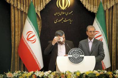 Iranian Deputy Health Minister Iraj Harirchi (L) wipes the sweat off his face, during a press conference with the Islamic republic's government spokesman Ali Rabiei in the capital Tehran on February 24, 2020. - Iran's deputy health minister confirmed on February 25, that he has tested positive for the novel coronavirus, amid a major outbreak in the Islamic republic. Harirchi coughed occasionally and appeared to be sweating during the press conference with Rabiei in Tehran. (Photo by Mehdi BOLOURIAN / FARS NEWS / AFP)