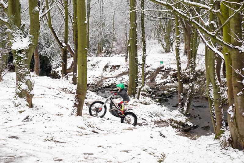 A young trials rider takes on a snowy incline near Castleside, County Durham. PA