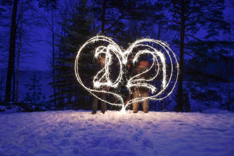 Revelers write "2021" in a heart shape with sparkler candles in Lahti, Finland. EPA