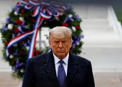 US President Donald Trump turns after placing a wreath at the Tomb of the Unknown Solider as he attends a Veterans Day observance in the rain at Arlington National Cemetery in Arlington, Virginia, US.  Reuters