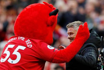 Manchester United manager Ole Gunnar Solskjaer with their mascot before the match. Reuters