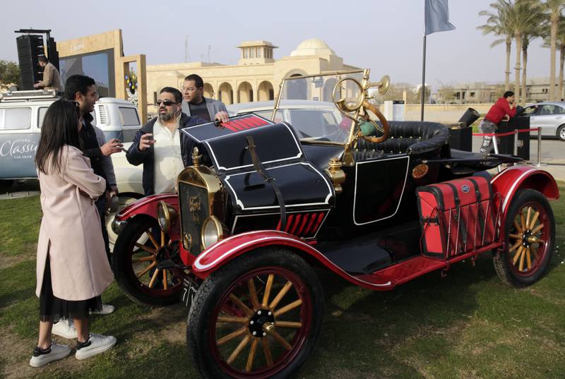 Egyptian collector Mohamed Wahdan talks to people about his 1924 Ford T at a public show in Cairo, Egypt, Saturday, March 19, 2022.  The car once belonged to Egypt's King Farouk's and is a part of over 250 vintage, antique and classic cars Wahdan collected over the past 20 years.  (AP Photo / Amr Nabil)