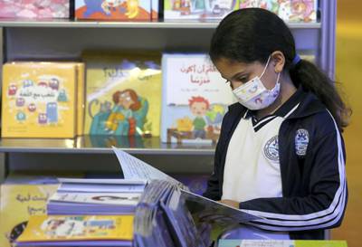 Sharjah, United Arab Emirates - Reporter: Razmig Bedirian. Arts and Culture. Tala aged 9 a visitor to Sharjah International Book Fair reads a book. Thursday, November 5th, 2020. Sharjah. Courtesy of Nathaniel Alapide
