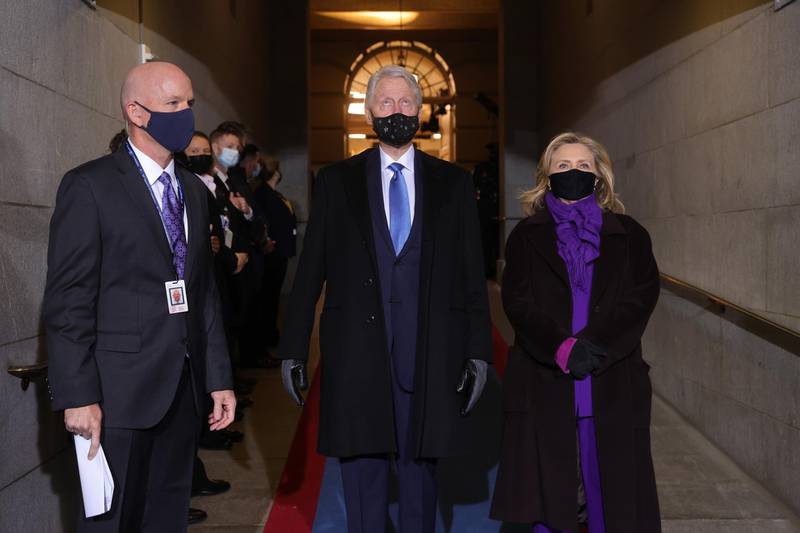 Former U.S. President Bill Clinton, center, and Hillary Clinton, former U.S. secretary of state, arrive to the 59th presidential inauguration in Washington, D.C., U.S., on Wednesday, Jan. 20, 2021. Biden will propose a broad immigration overhaul on his first day as president, including a shortened pathway to U.S. citizenship for undocumented migrants - a complete reversal from Donald Trump's immigration restrictions and crackdowns, but one that faces major roadblocks in Congress. Photographer: Win McNamee/Getty Images/Bloomberg